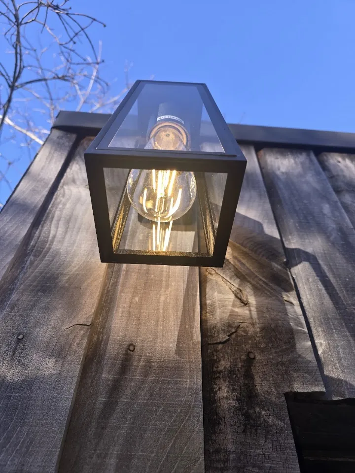 Outdoor lantern light on a timber fence