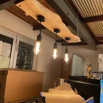 Row of pendant lights hanging from a timber beam